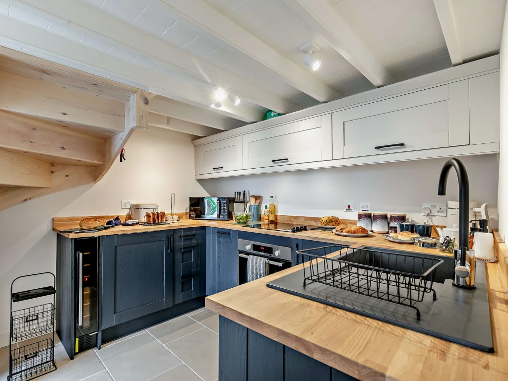 Navy and oak kitchen with wine cooler and induction hob