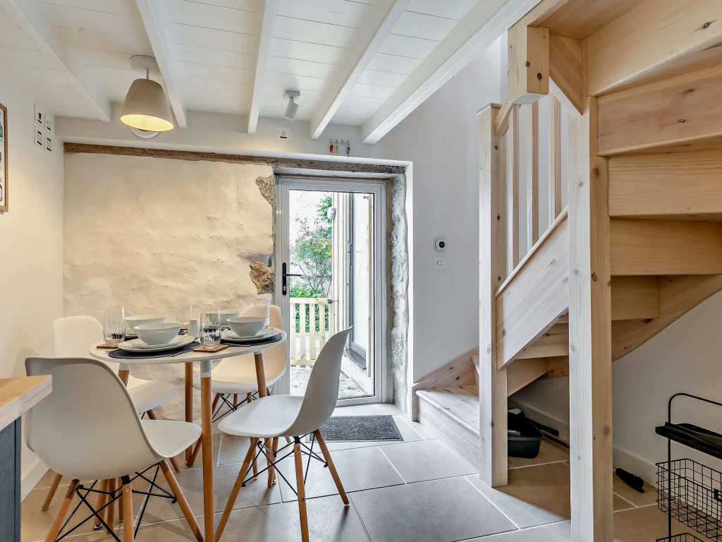 Dining area, wooden stairs and door to the courtyard