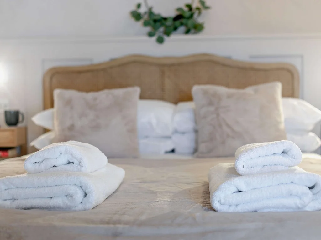King bed made up with towels for guests