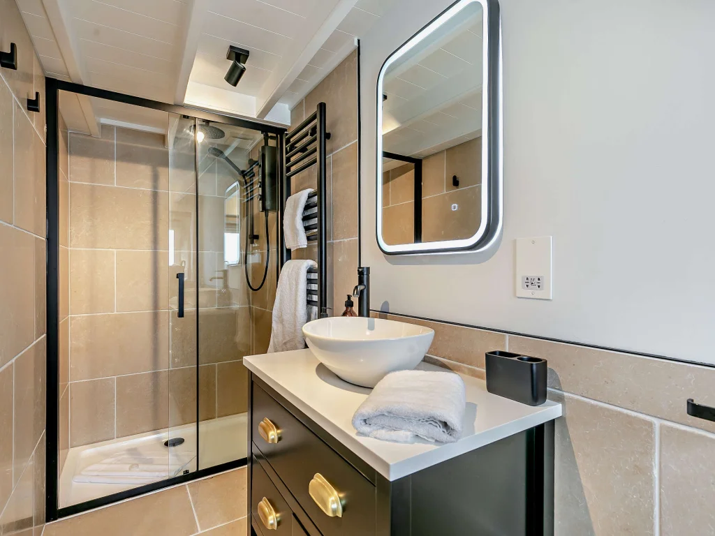 Walk-in shower and vessel sink in the renovated bathroom