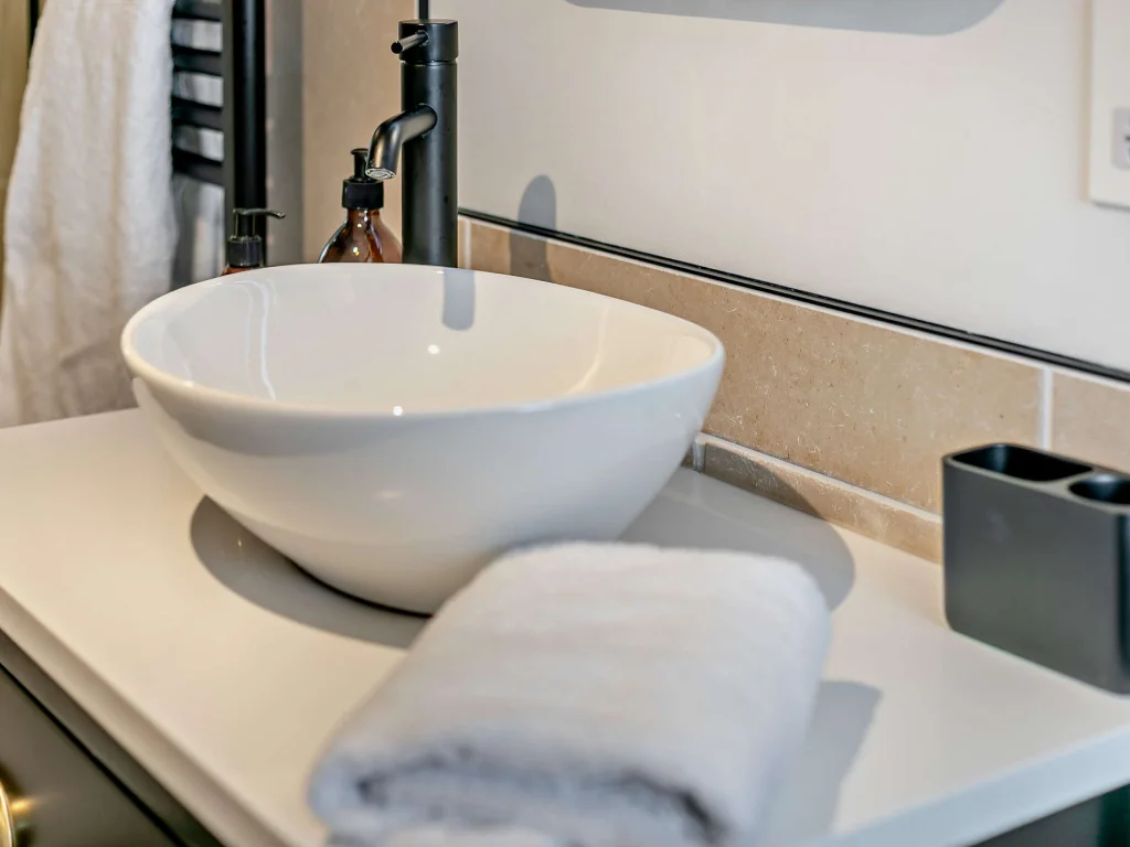 White vessel sink and matte black tap